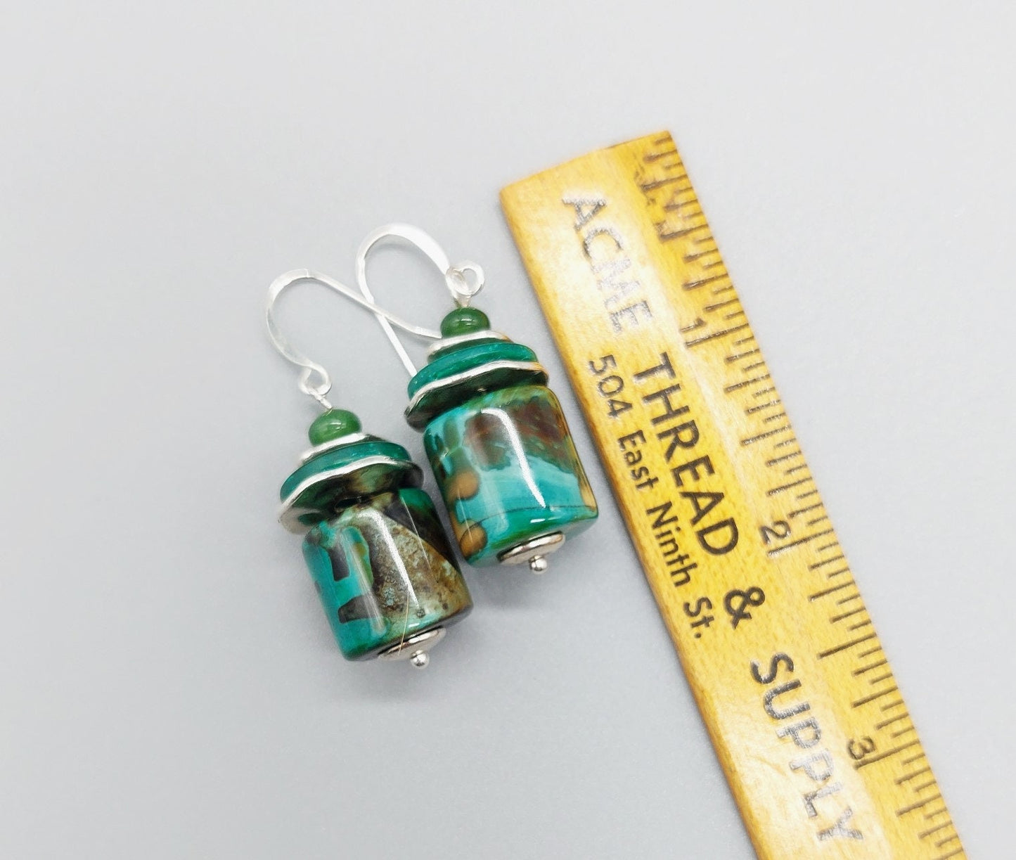 Green multi toned earrings with silver discs